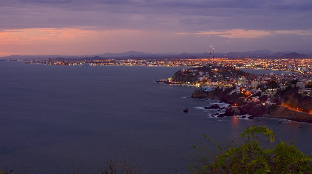 El Faro Lighthouse featuring night scenes, a coastal town and landscape views