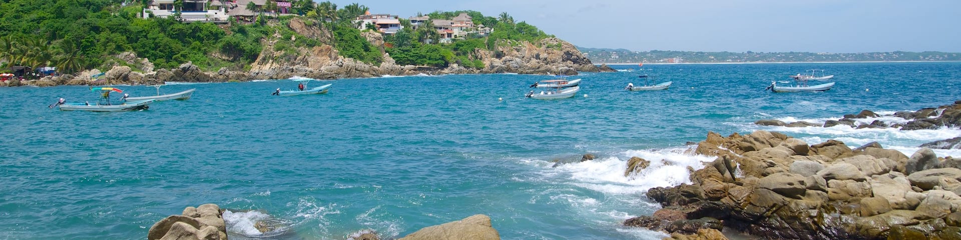 Puerto Angelito Beach showing rocky coastline and a bay or harbor