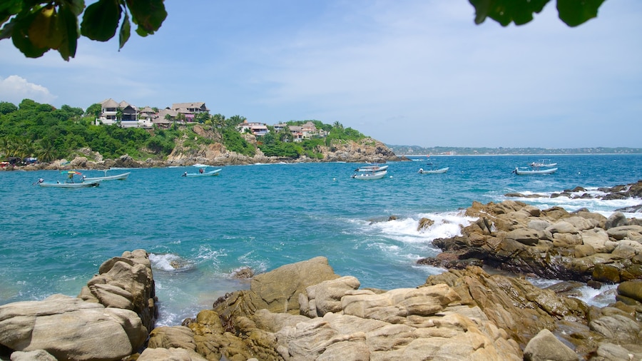 Puerto Angelito Beach which includes a bay or harbour and rocky coastline
