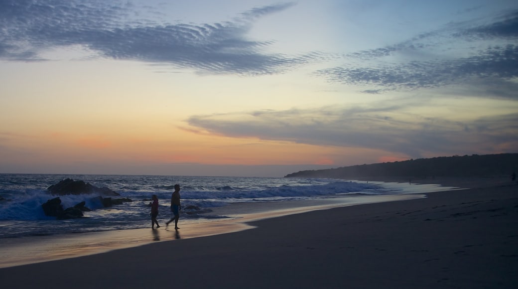 Bacocho Beach which includes a sandy beach, landscape views and a sunset