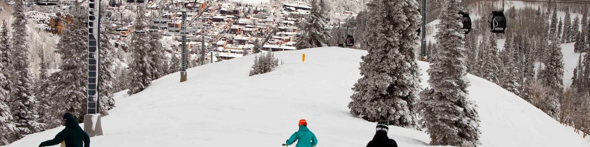 Aspen Mountain which includes a small town or village, snow boarding and snow skiing