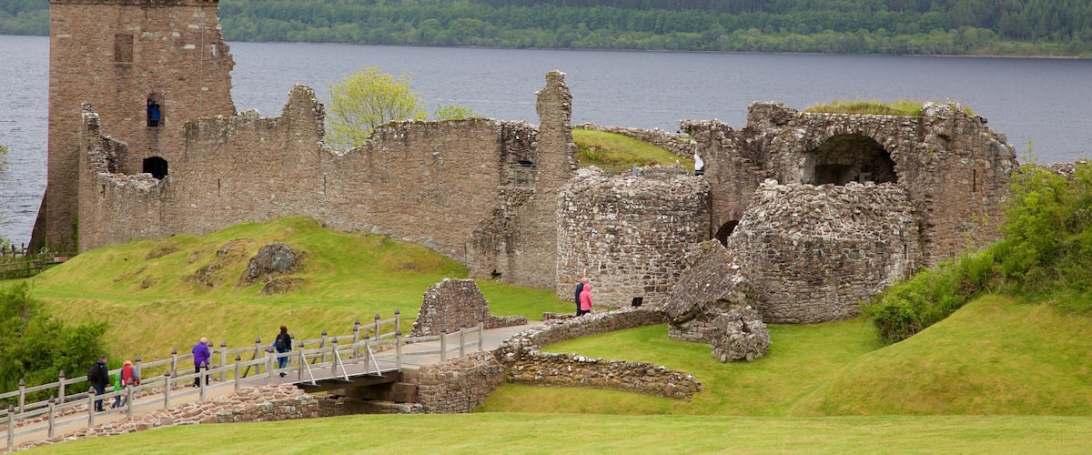 Urquhart Castle showing a lake or waterhole and building ruins