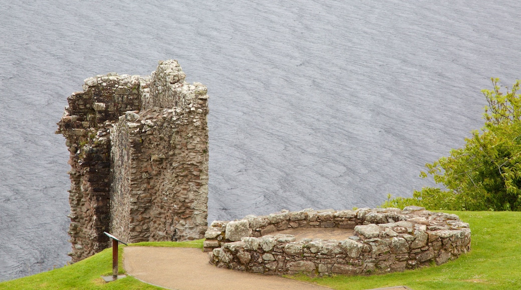 Urquhart Castle which includes a lake or waterhole and building ruins