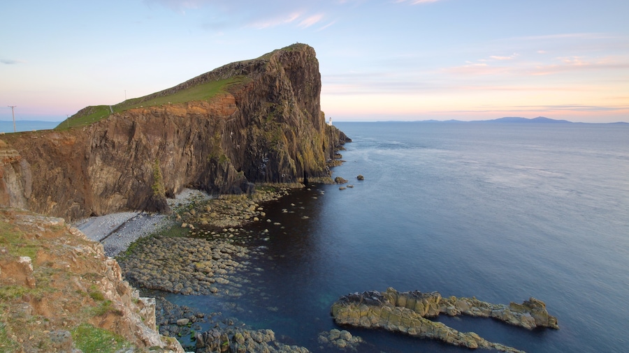 Isle of Skye featuring a lighthouse, rugged coastline and mountains