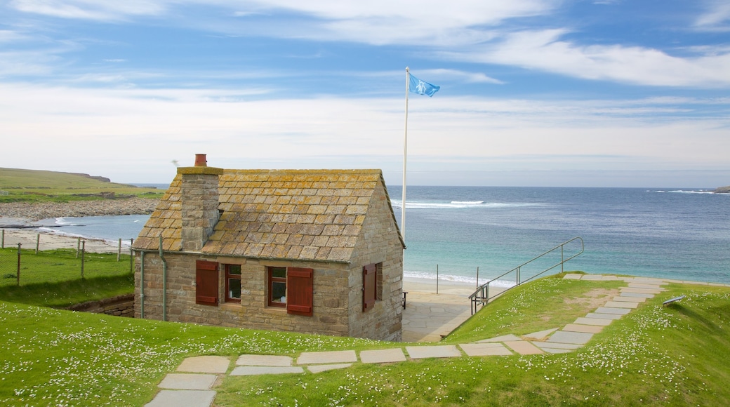 Skara Brae showing a bay or harbour, a beach and a house