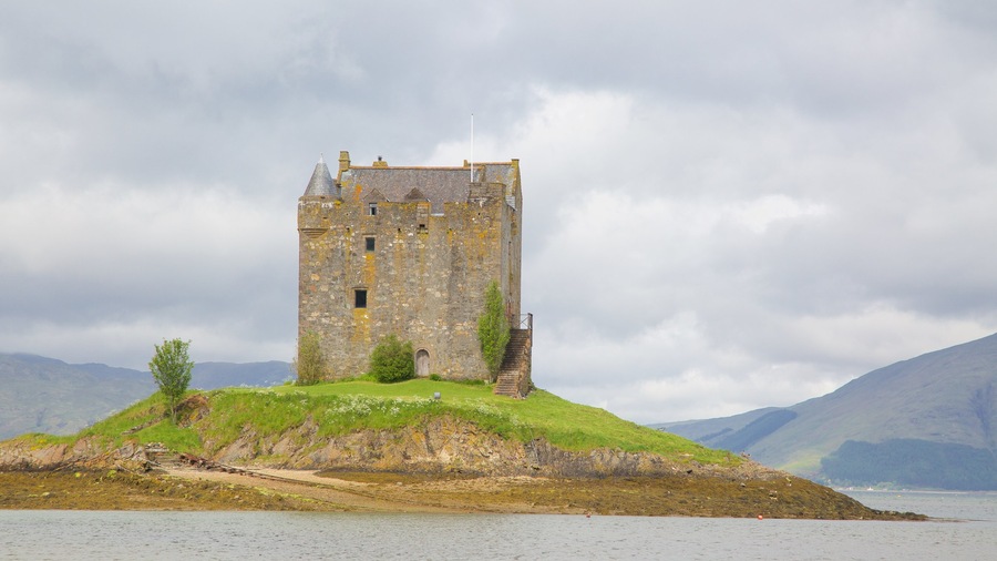 Castle Stalker featuring a lake or waterhole, chateau or palace and heritage architecture