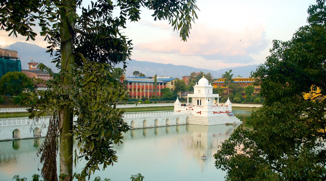 Nepal showing a temple or place of worship, a lake or waterhole and a bridge