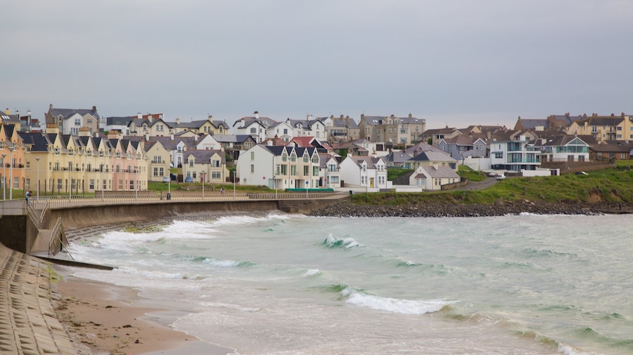 Portrush Beach which includes a sandy beach, a coastal town and general coastal views