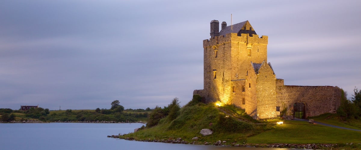 Dunguaire Castle which includes heritage architecture, a castle and a river or creek
