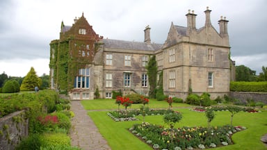 Muckross House featuring a garden, heritage architecture and flowers