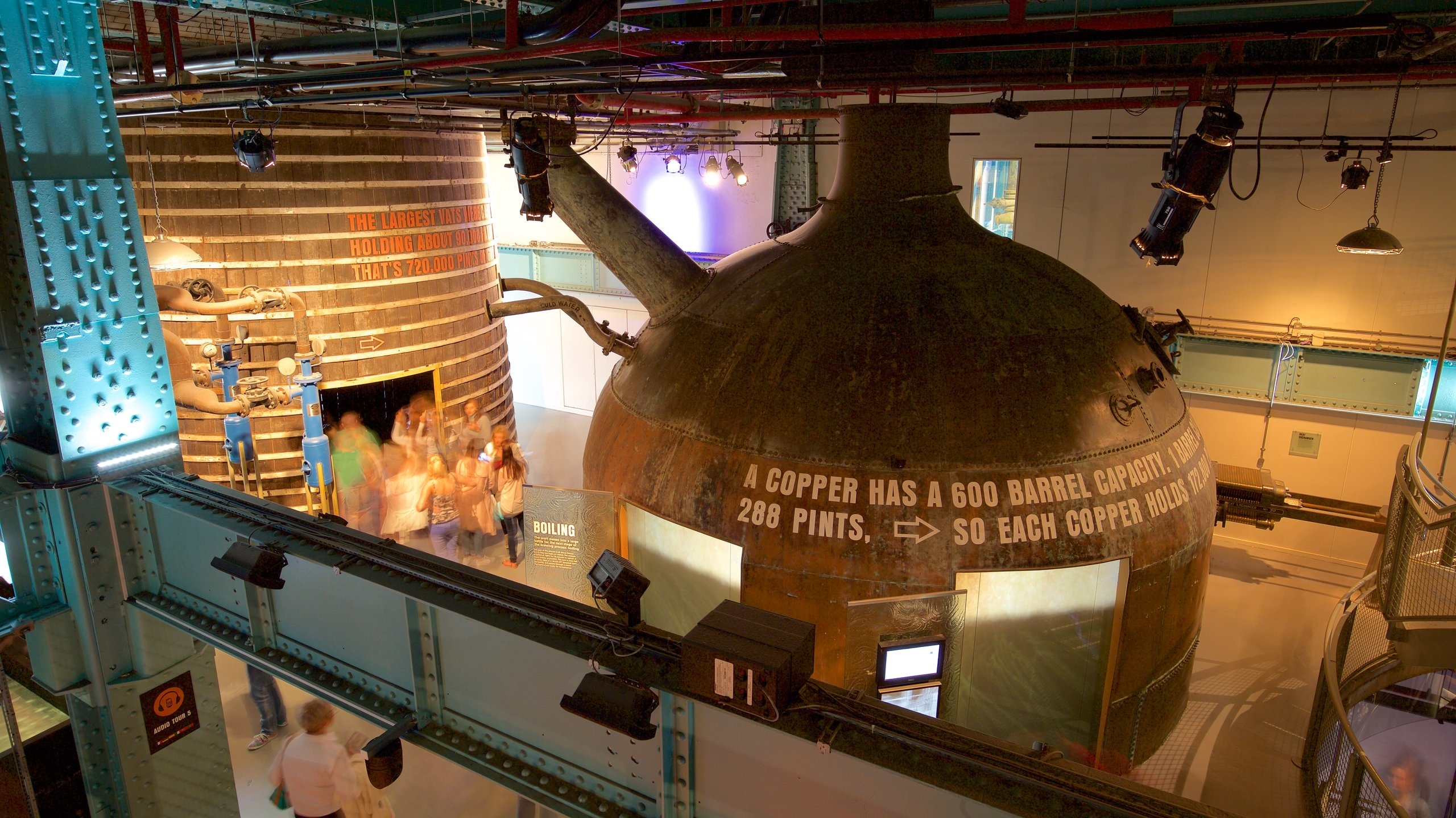 Interior view of the Guinness Storehouse featuring large brewing vessels and informative displays about the brewing process.