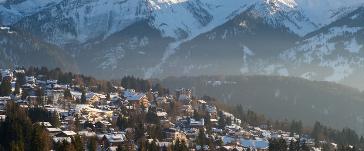 Gryon mostrando montañas, una pequeña ciudad o pueblo y nieve