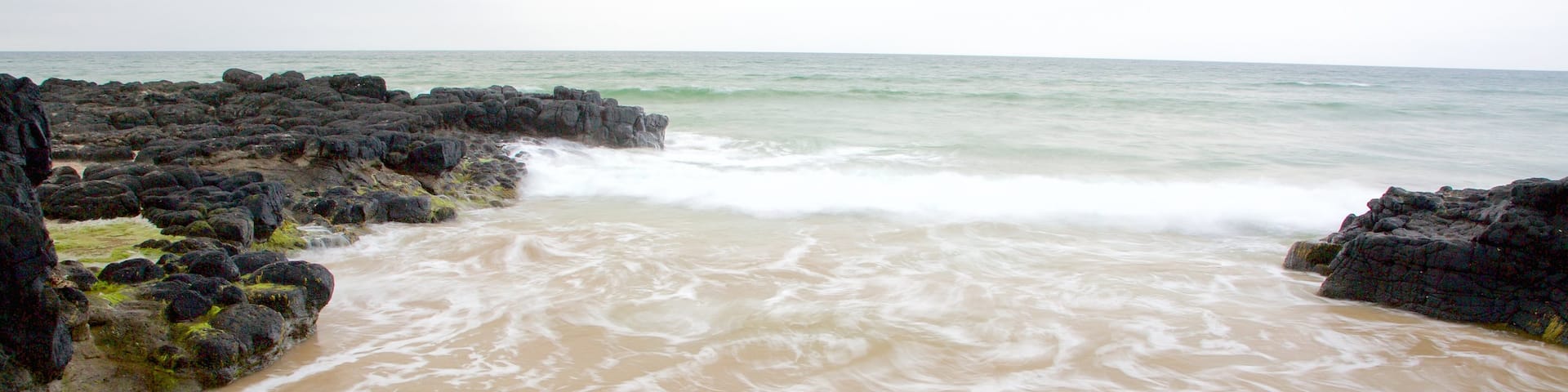 Castlerock Beach which includes rocky coastline, general coastal views and a beach