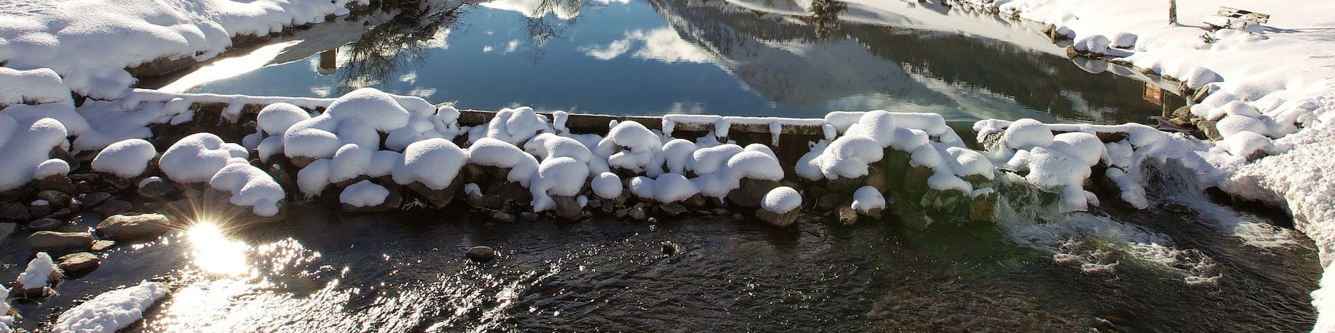 Livigno Ski Area featuring a pond, snow and tranquil scenes