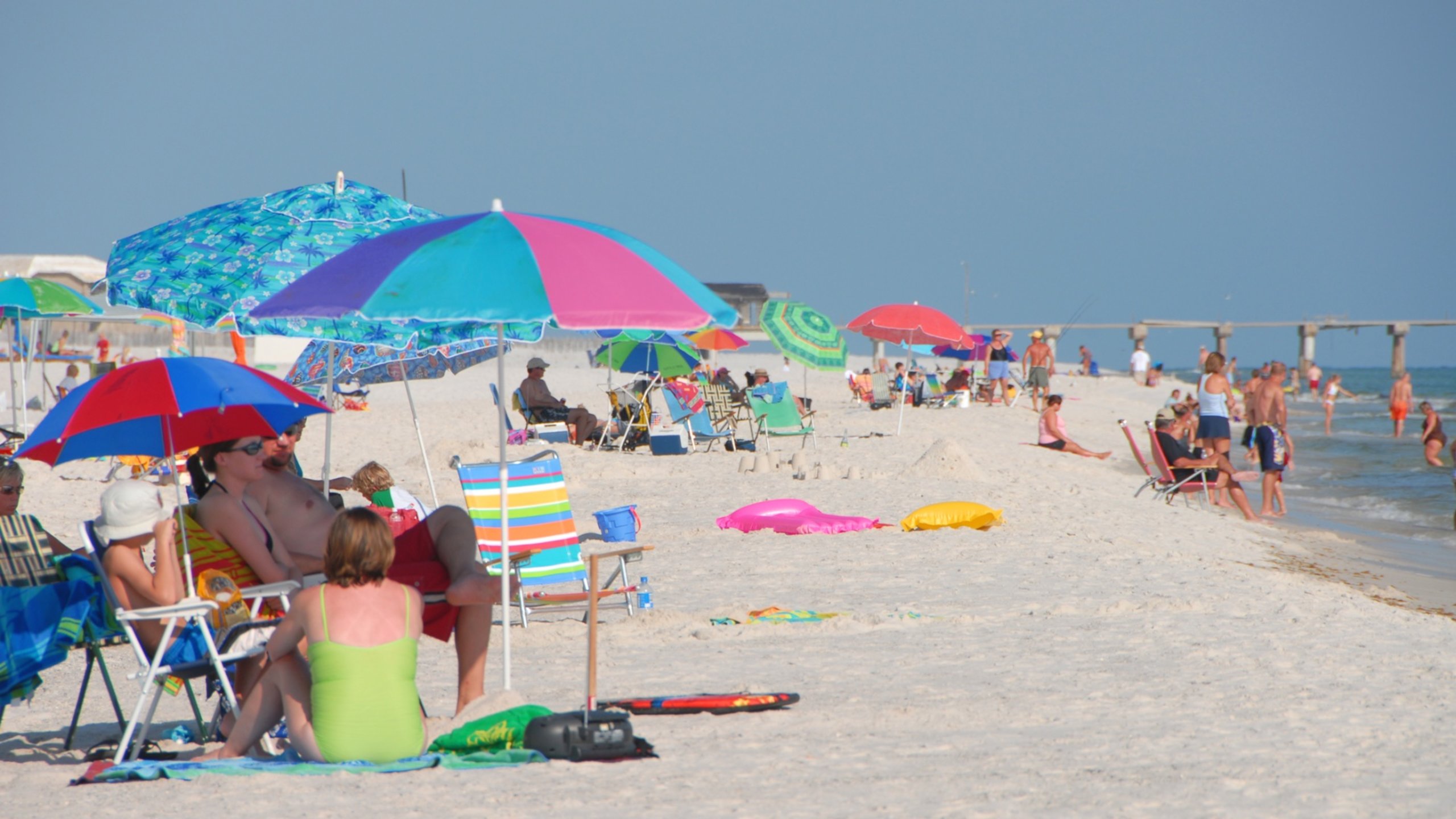 Gulf Shores showing general coastal views and a sandy beach as well as a small group of people