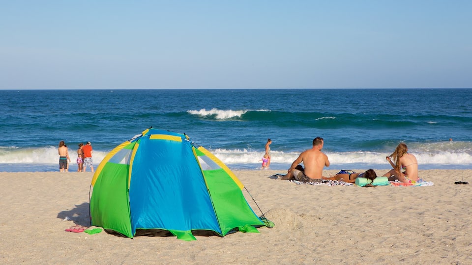 Wrightsville Beach which includes a beach as well as a small group of people