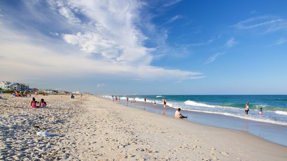 Wrightsville Beach featuring a beach as well as a small group of people
