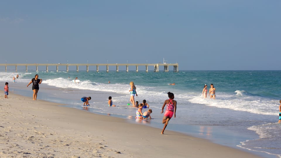 Wrightsville Beach showing a beach as well as a small group of people