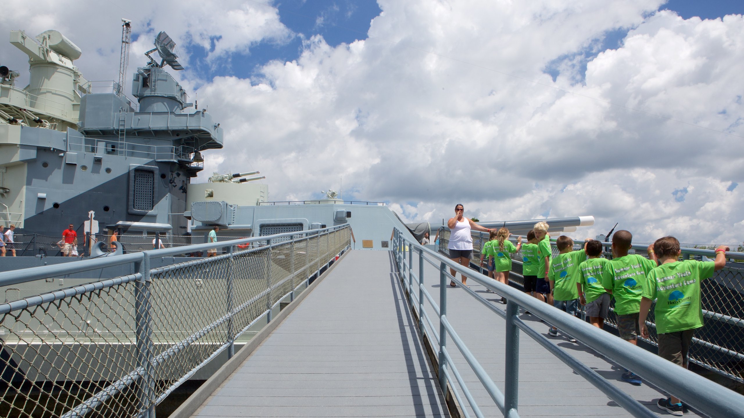 Battleship North Carolina showing heritage elements as well as a small group of people