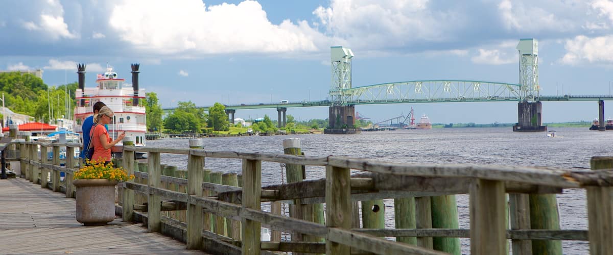 Wilmington featuring a river or creek and a bridge as well as a couple