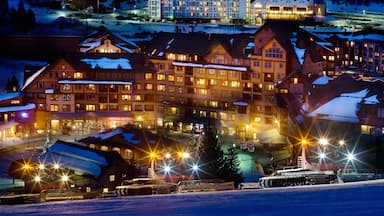 Winter Park showing night scenes, a luxury hotel or resort and snow