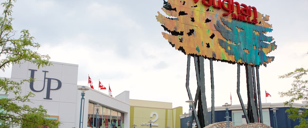 Vaughan Mills Mall featuring a square or plaza and signage as well as a small group of people