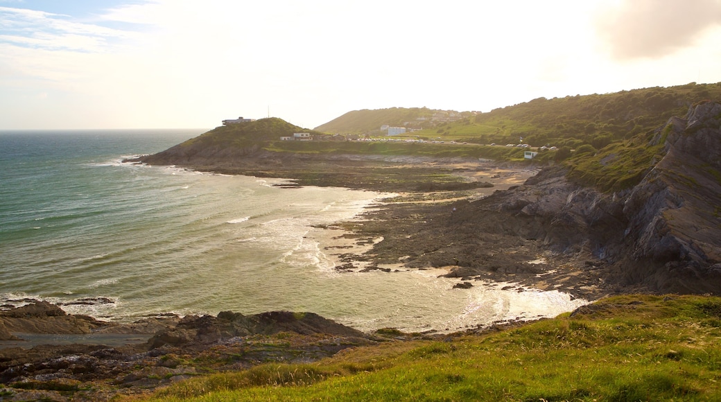 Bracelet Bay Beach showing rugged coastline, a bay or harbour and landscape views