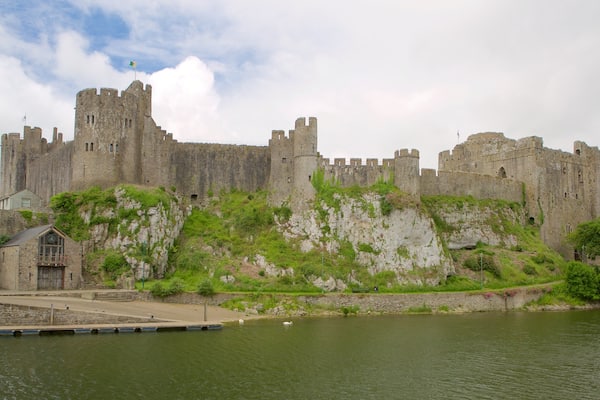 Pembroke Castle showing a river or creek, château or palace and heritage elements
