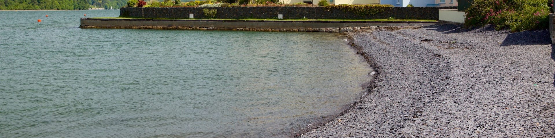 Y Felinheli showing a pebble beach and a small town or village