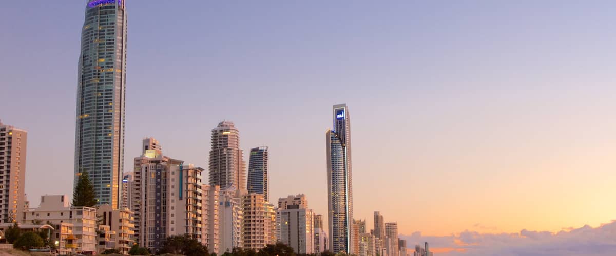 Surfers Paradise showing a sunset, a beach and a city