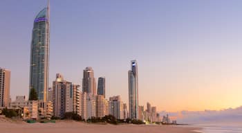 Surfers Paradise showing a city, a sunset and a sandy beach