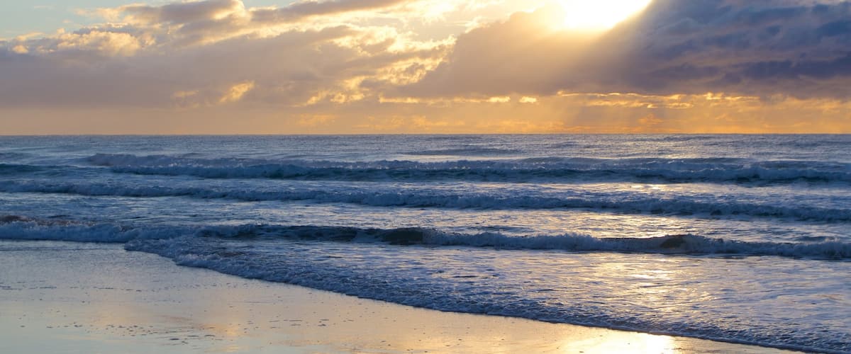 Surfers Paradise showing a beach and a sunset