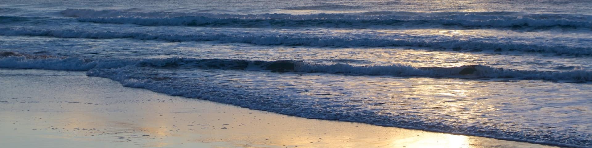 Surfers Paradise showing a beach and a sunset