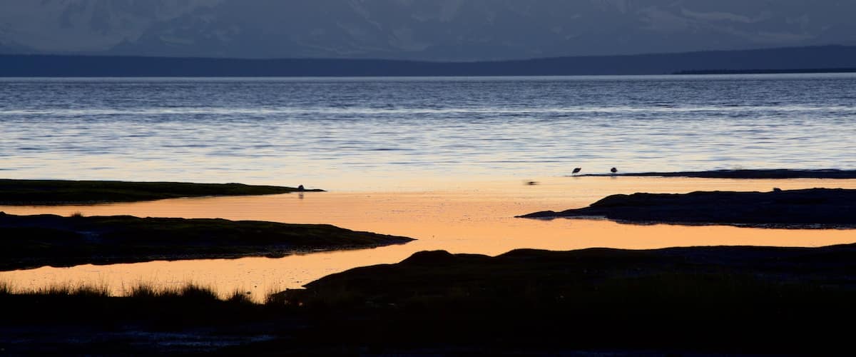 Anchorage showing mountains, general coastal views and a sunset
