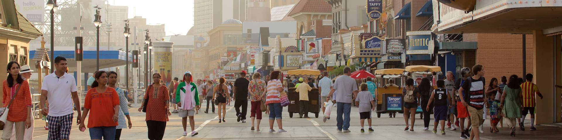 Atlantic City Boardwalk showing rides and street scenes as well as a large group of people