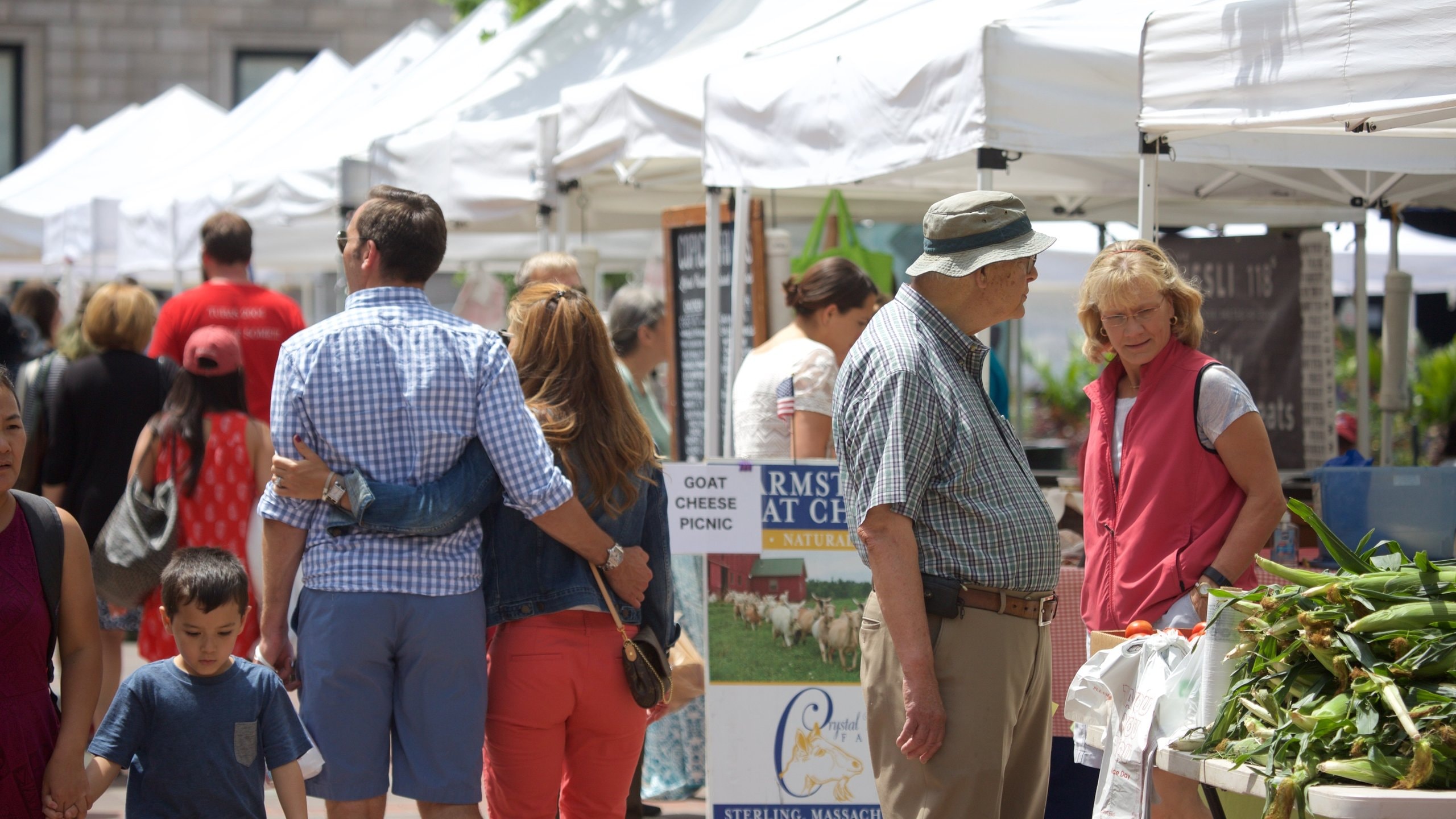 Back Bay featuring markets as well as a large group of people