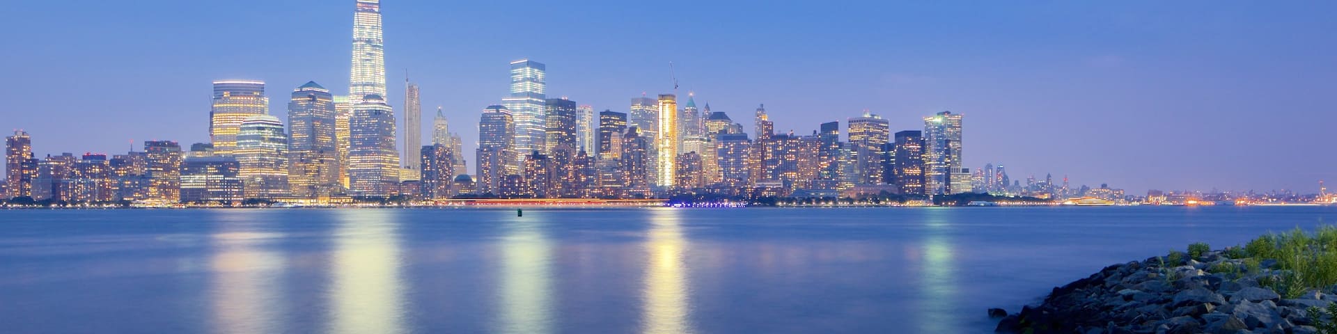 Liberty State Park which includes a city, a river or creek and a sunset