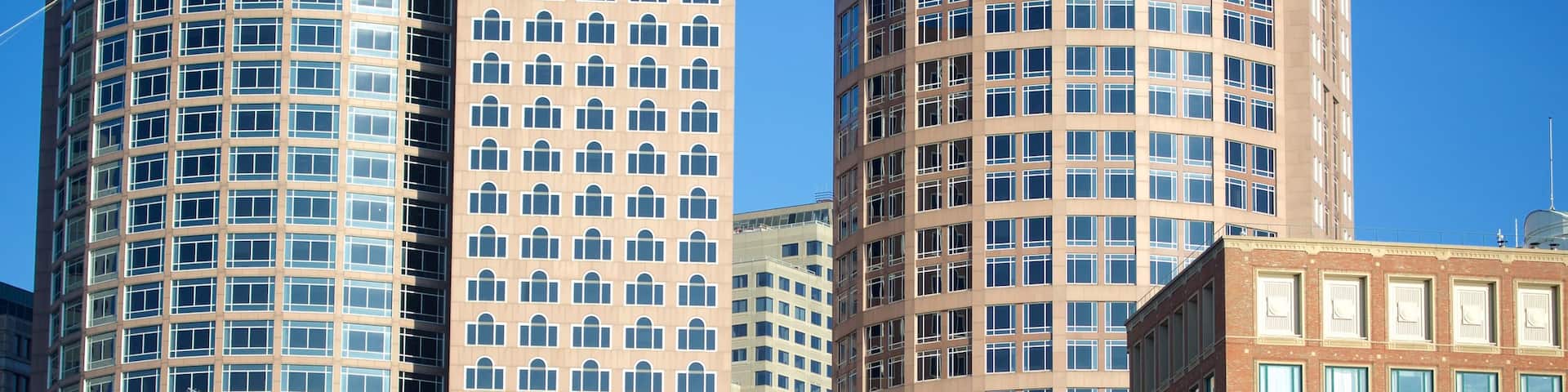 Seaport District showing a city and city views as well as a large group of people