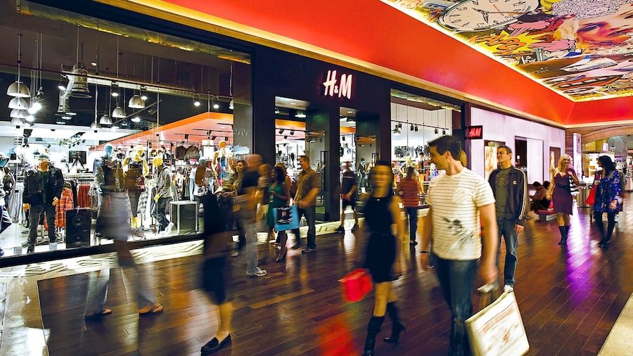 Miracle Mile Shops which includes interior views as well as a large group of people