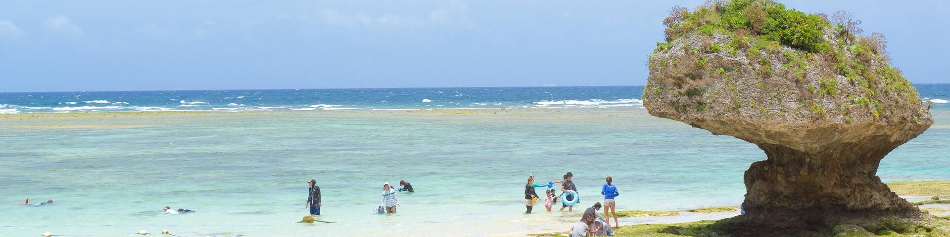 Nirai Beach which includes a sandy beach as well as a large group of people