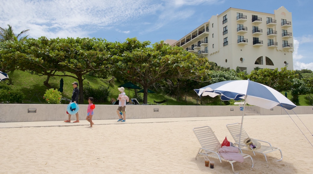 Nirai Beach featuring a sandy beach and a hotel as well as children