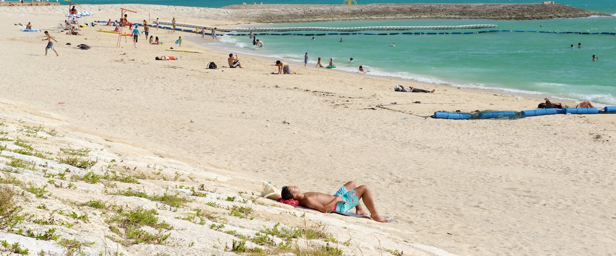 Toyosaki Chura Sun Beach which includes swimming, a sandy beach and general coastal views