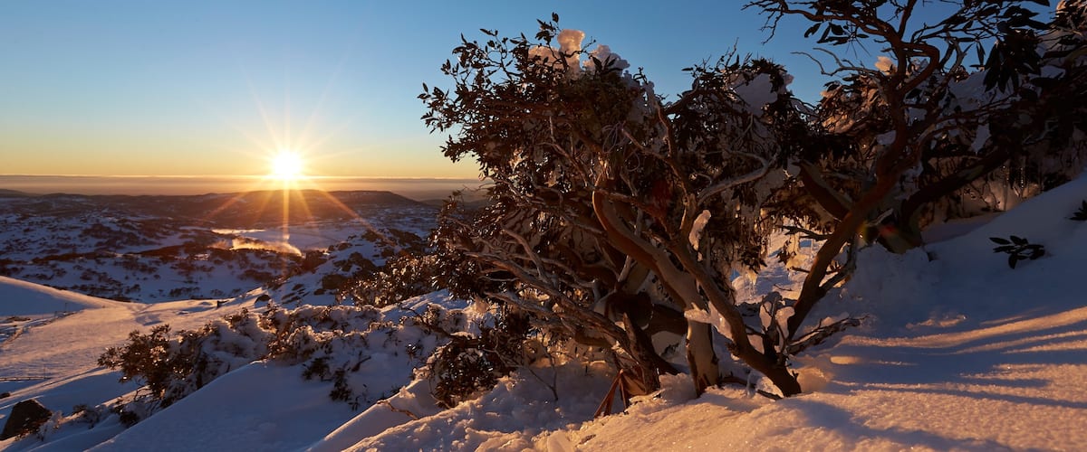 Perisher Ski Resort which includes landscape views, a sunset and snow