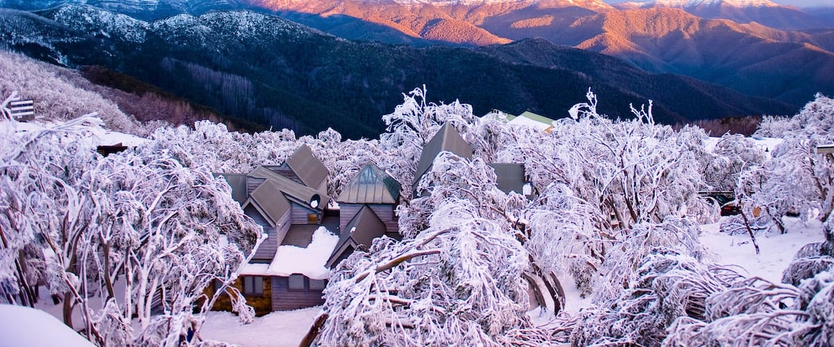 Mt. Buller Ski Slopes showing mountains, a sunset and a small town or village