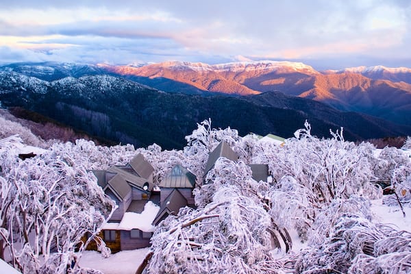 Mt. Buller Ski Slopes showing mountains, a sunset and a small town or village