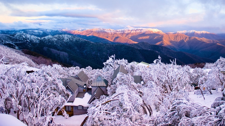 Mt. Buller Ski Slopes which includes a sunset, a small town or village and snow