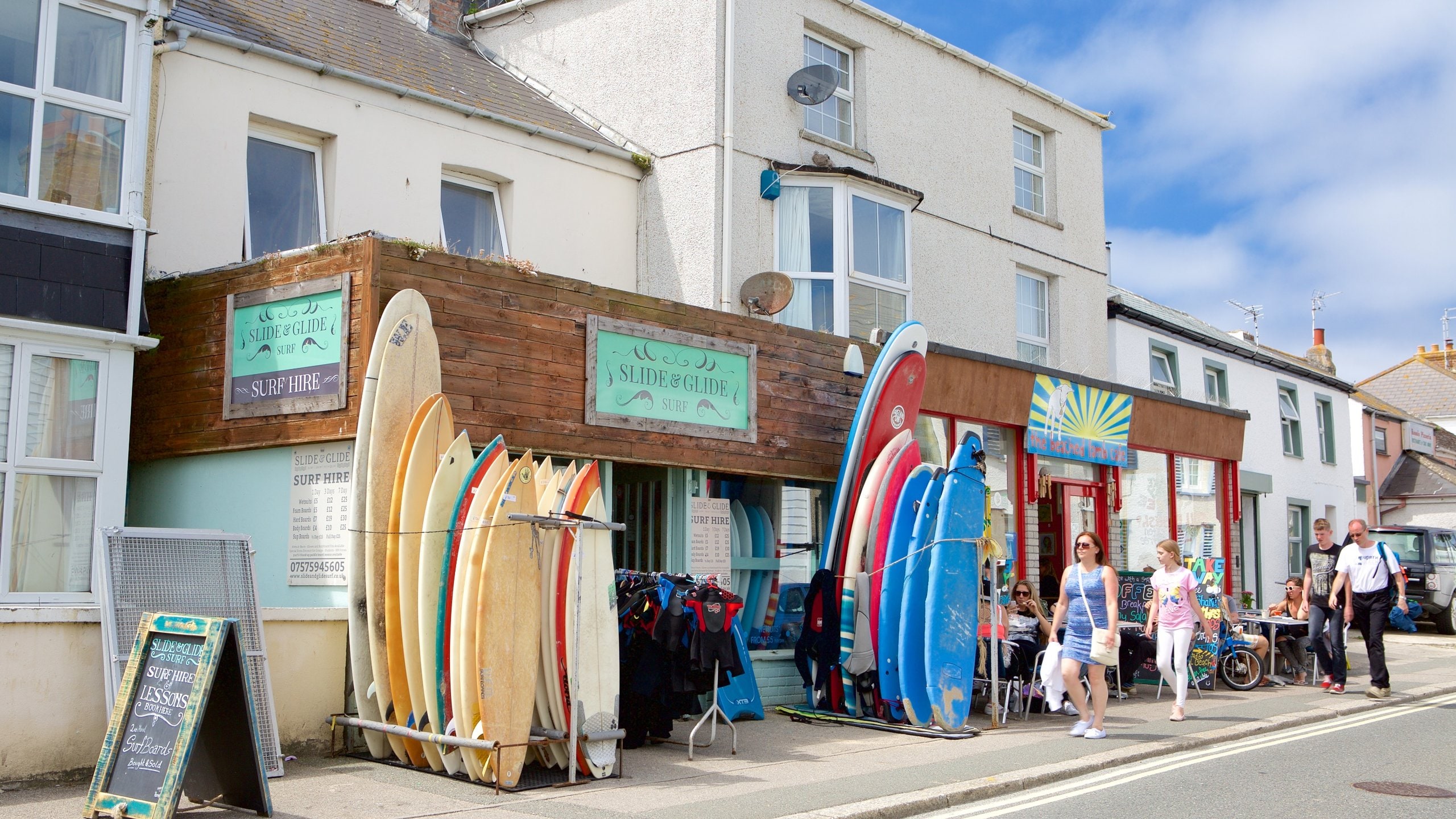 Newquay which includes signage, a coastal town and street scenes