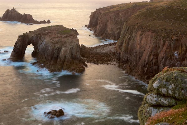 Land\'s End featuring a sunset, rugged coastline and general coastal views