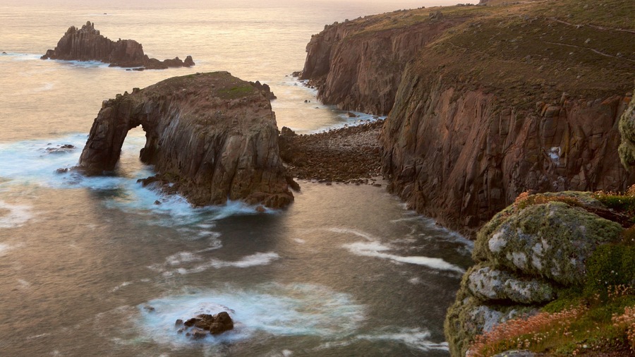 Land\'s End featuring a sunset, rugged coastline and general coastal views