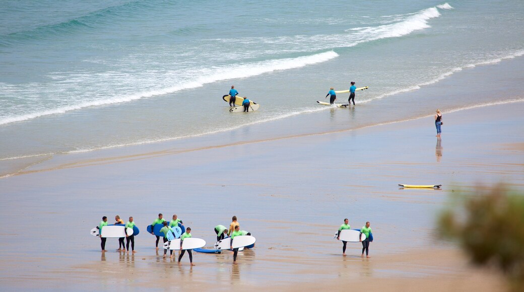 Newquay which includes a beach and surfing as well as a large group of people